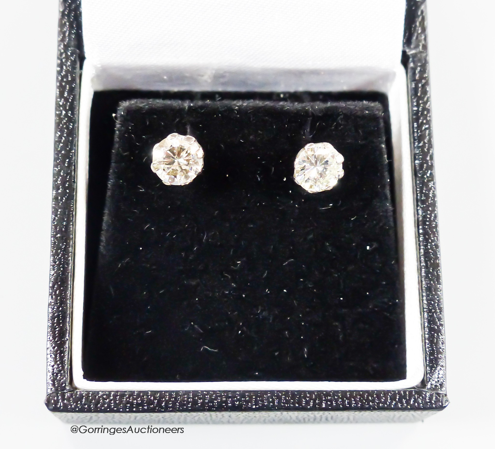 A modern pair of 18ct and solitaire diamond set ear studs, each stone weiging approximately 0.65ct-0.70ct, gross weight 2.2 grams.